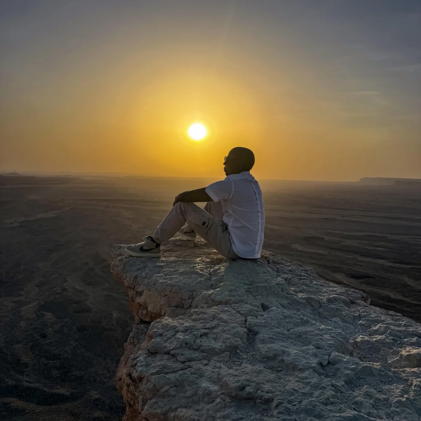 Shannon Allen seated in the desert at sunset
